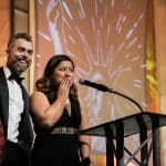 Two people on stage at ACLU Liberty Dinner 2019 with shocked and happy sentiments on their faces