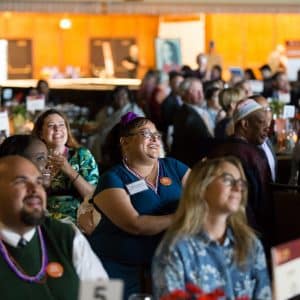 Guests at event fondly looking at stage