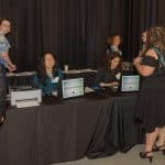 Candid photo of event volunteers working a registration station