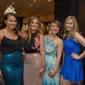 GlamHer staff posing while dressed in mermaid-themed attire