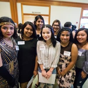 Youth volunteers from Adelante Mujeres posing together and smiling